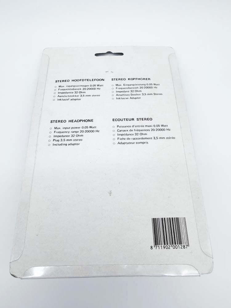 Back of white packaging listing stereo headphones specs in multiple languages, with a barcode on the lower right.